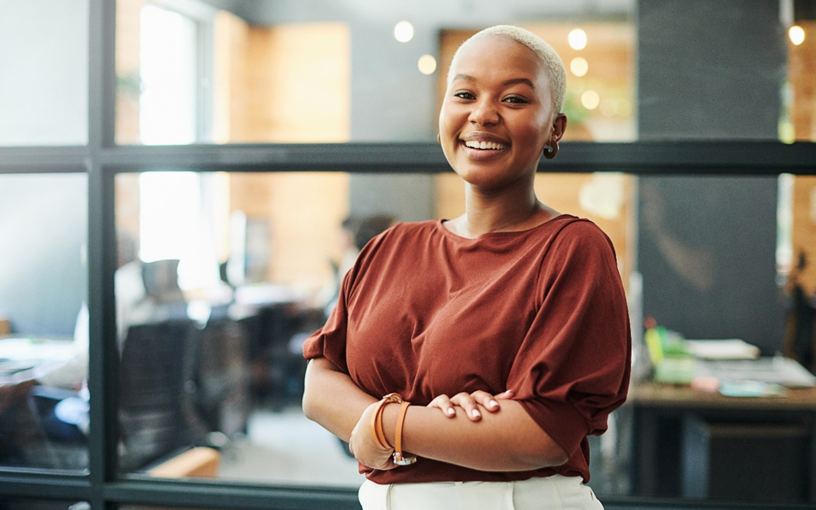 Smiling woman standing with arms crossed